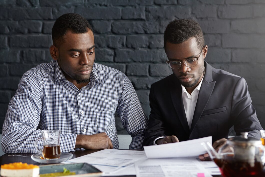 two-young-african-american-executives-reviewing-financial-report_273609-9162.jpg